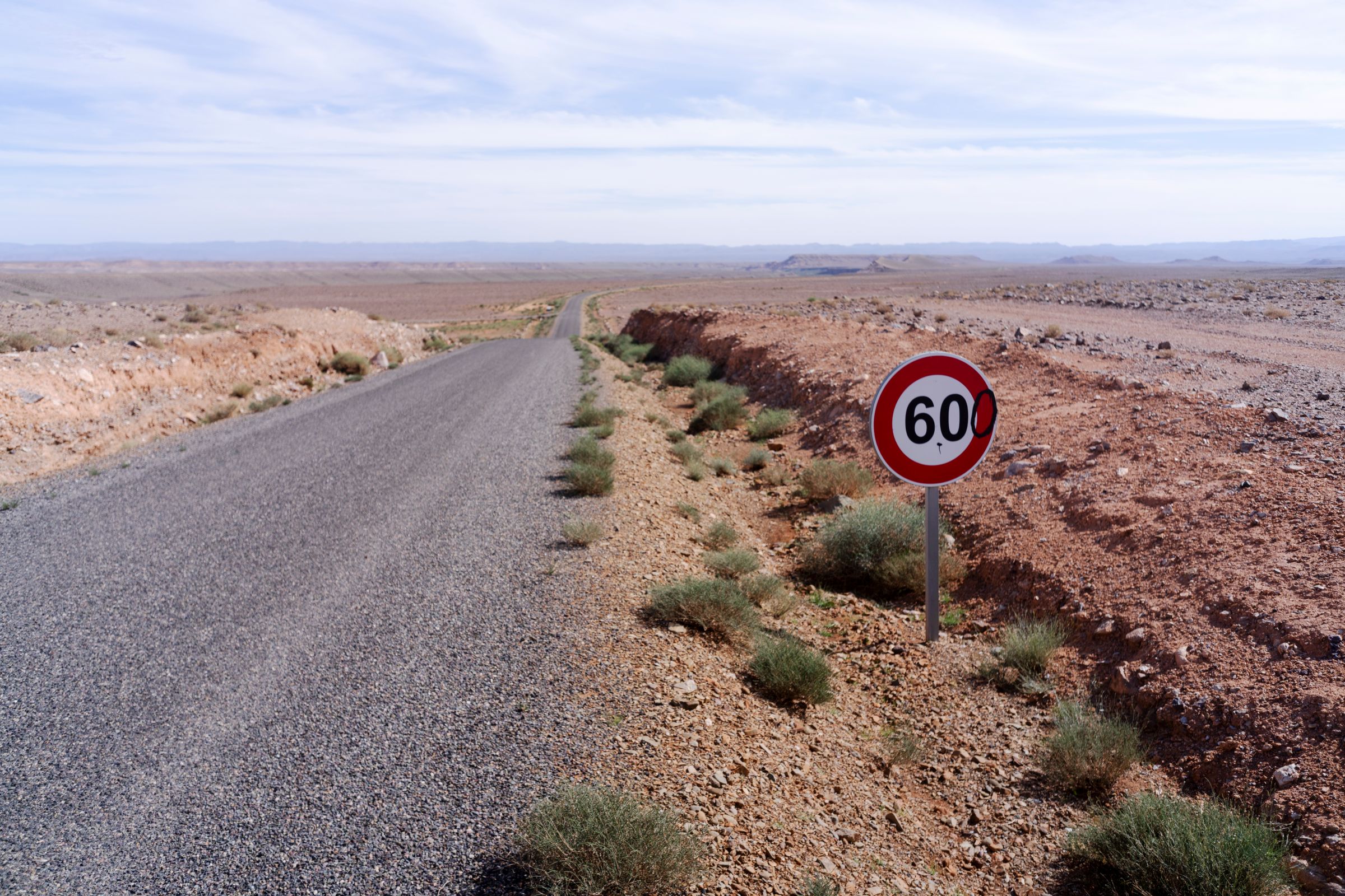 Empty Moroccan desert road stretching toward the horizon